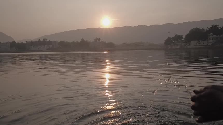Person splashing water in a lake
