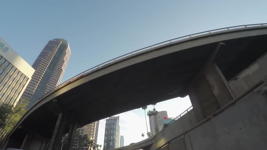 A car is driving under a bridge
