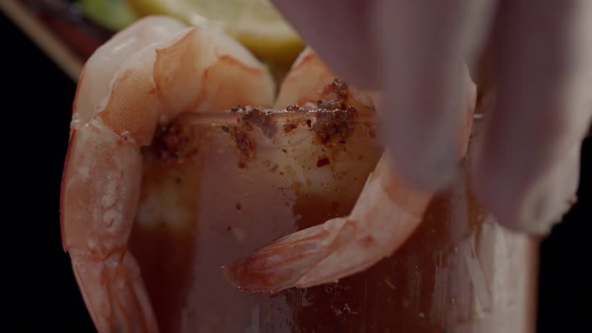 Shrimp are used as garnish on a beverage
