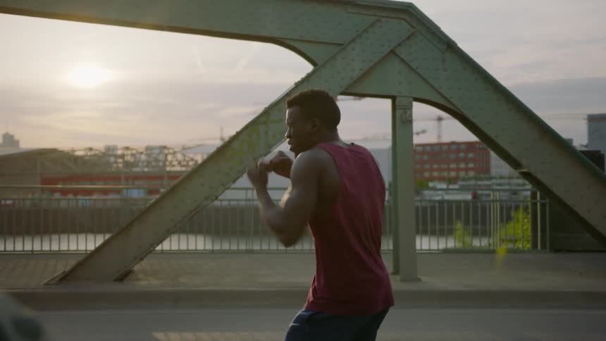 A man boxes on a bridge