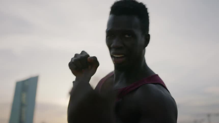 Man practicing punching outside at sunset