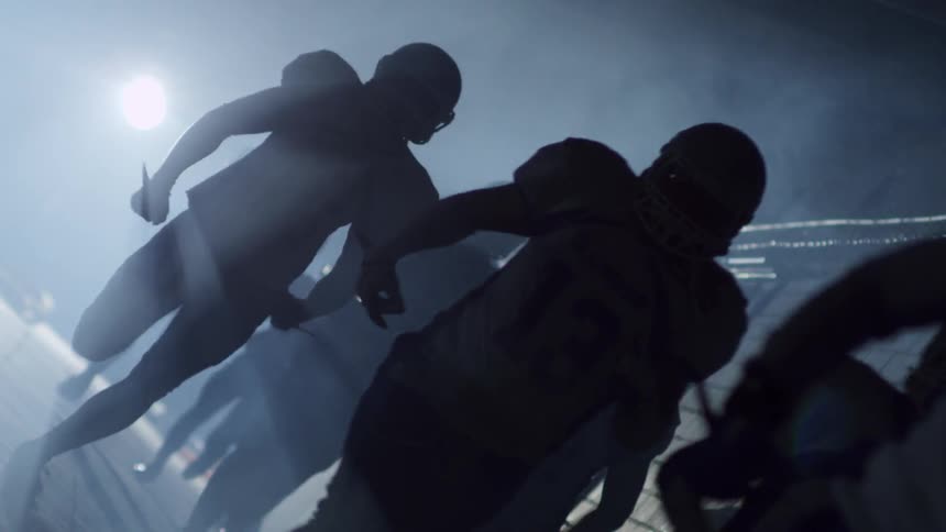 Players in uniform running down a hall