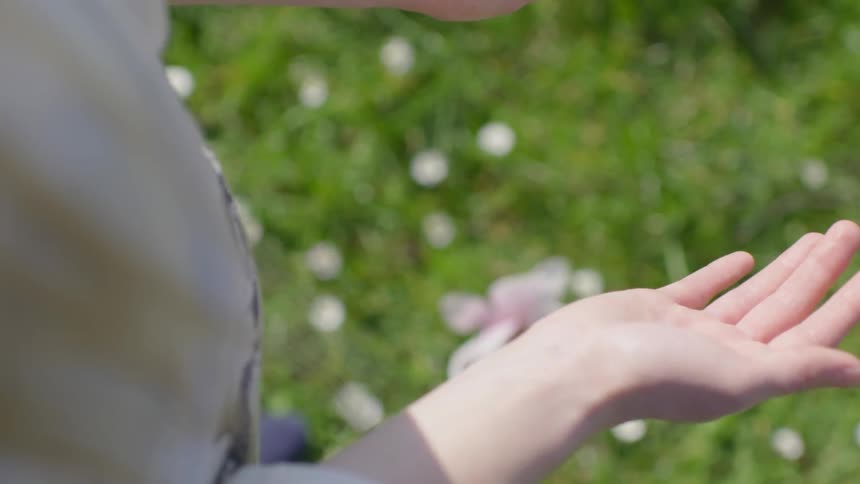 Woman drops a flower to the ground
