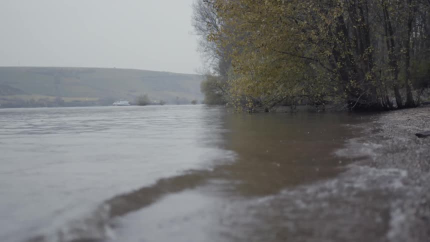 The water in the lake moves in waves towards the shore