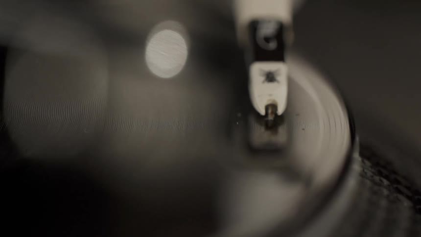 Water droplets are dropping onto a spinning record
