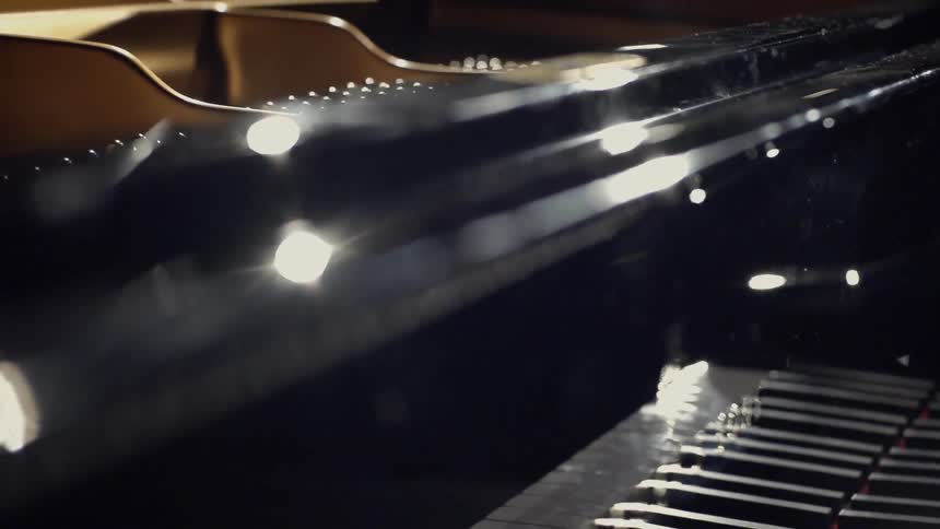 A light shines down on a piano