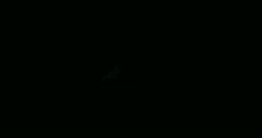 A flame ignites repeatedly in the dark