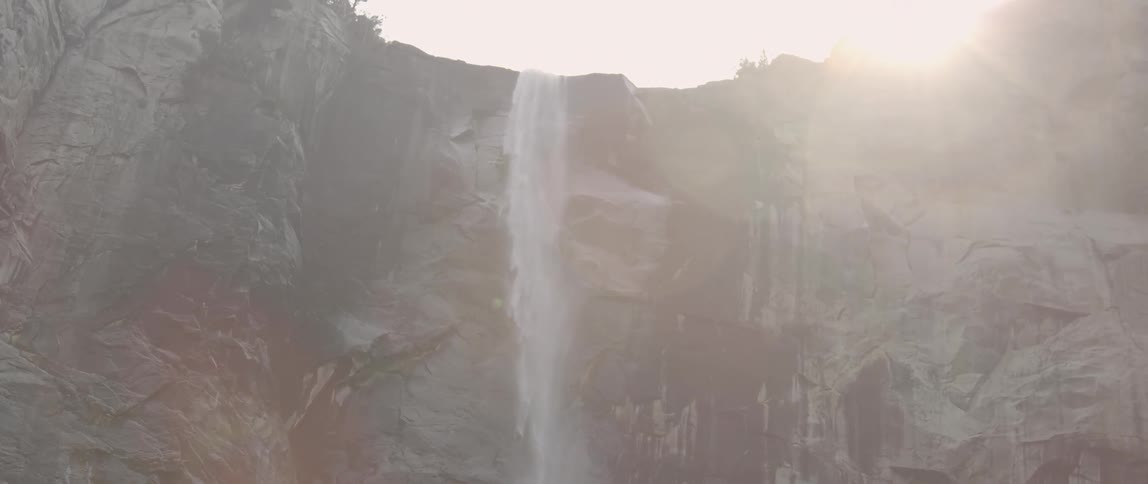 A waterfall is cascading down a mountain