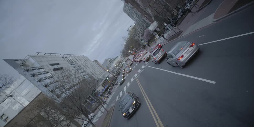 Cars driving down a busy city street