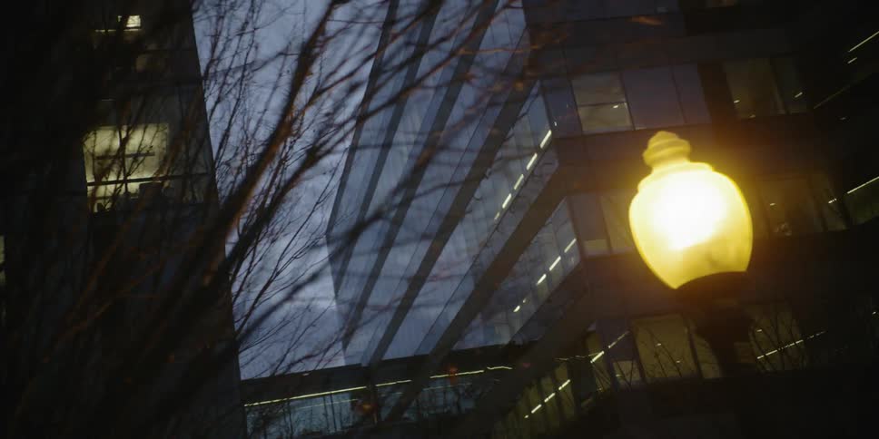 Lights are on inside glass office buildings