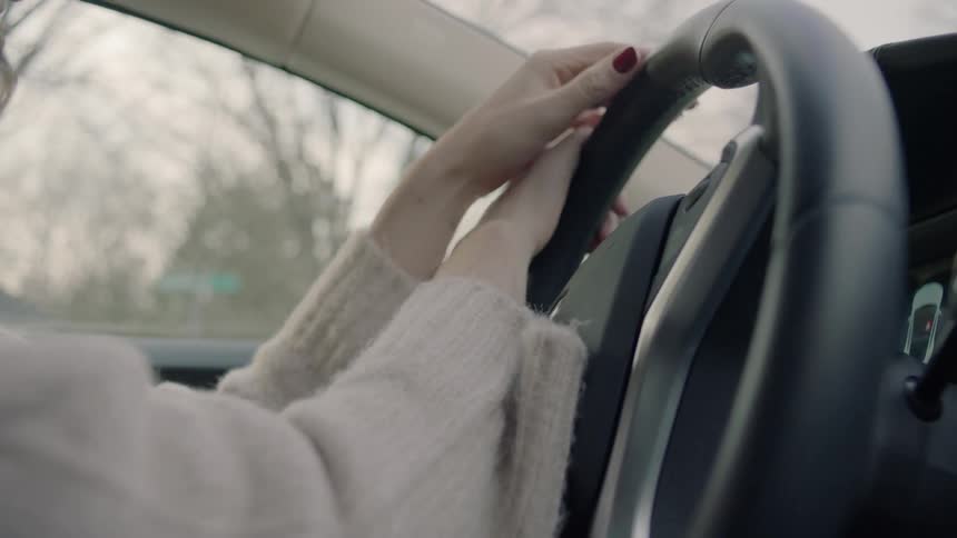 Woman makes a turn driving a car