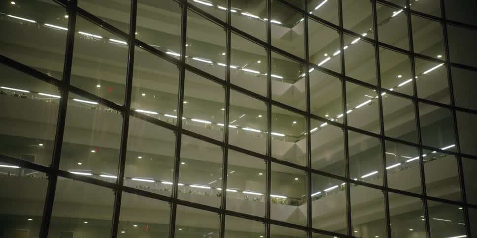 The interior of a building is lit up with lights on every floor at night
