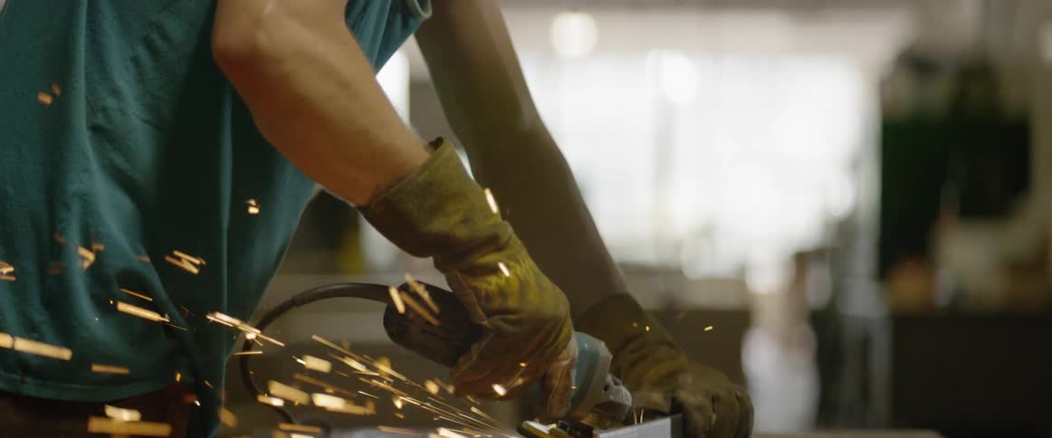 A man polishes a piece of metal