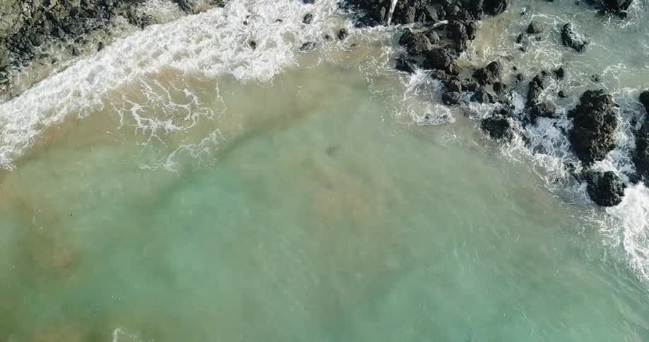 Ocean waves splash on the rocks as they come to shore