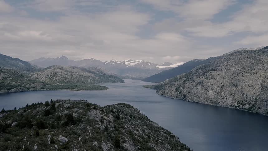 River flows through mountains on a cloudy day