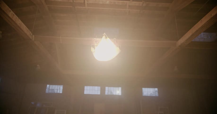 Spotlight glows in an empty warehouse