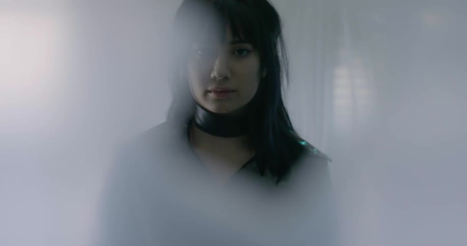 A young asian girl is wearing a large leather choker