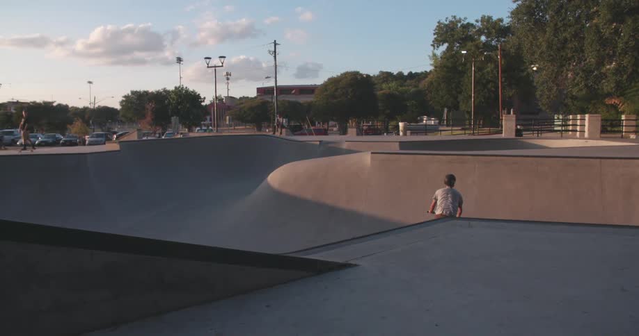 Man rides his bike down a steep slope and does a jump on the other end