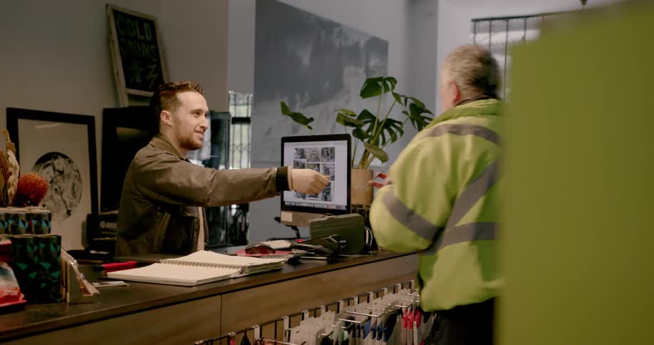 A man signs for a package in a bicycle shop