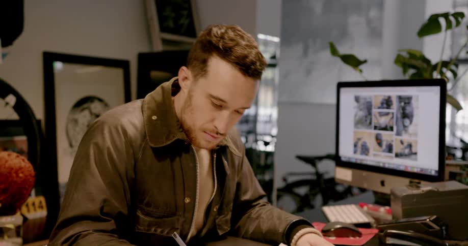Man using calculator and writing things down at desk