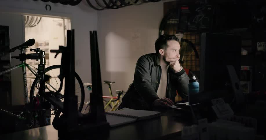 Man using computer in a dark room