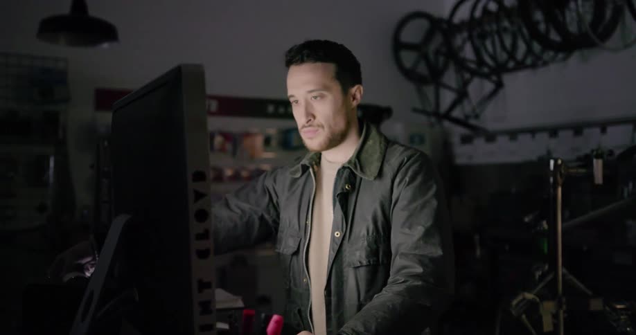 A man works on a shop computer