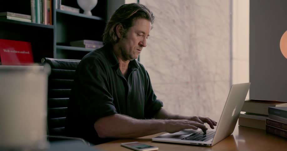 Man types on a laptop