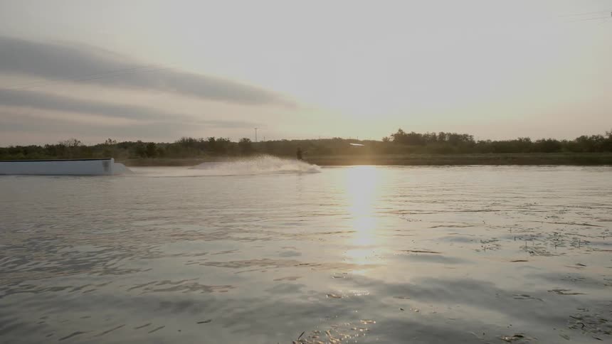 Someone performing a trick while wake surfing