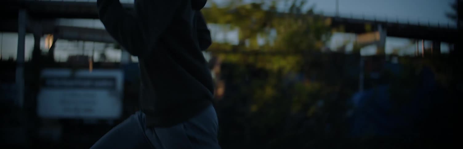 A man is running full speed down a road
