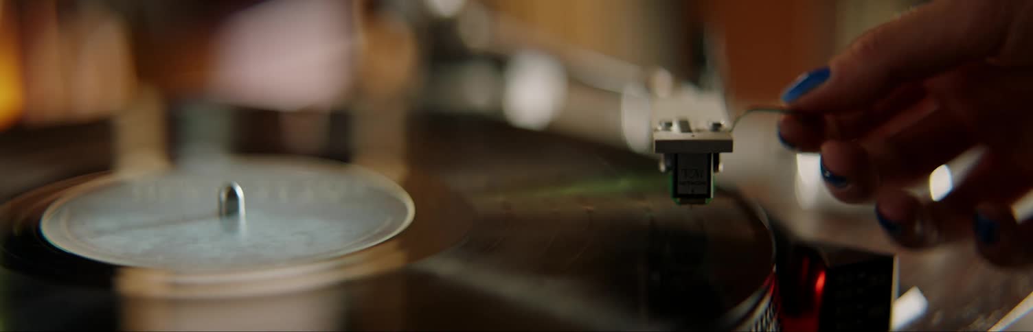 Person placing record on record player