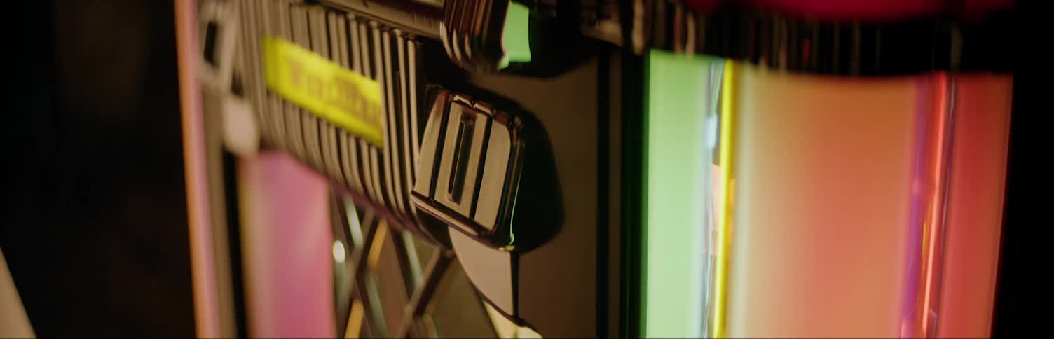 Person inserting coin into jukebox 