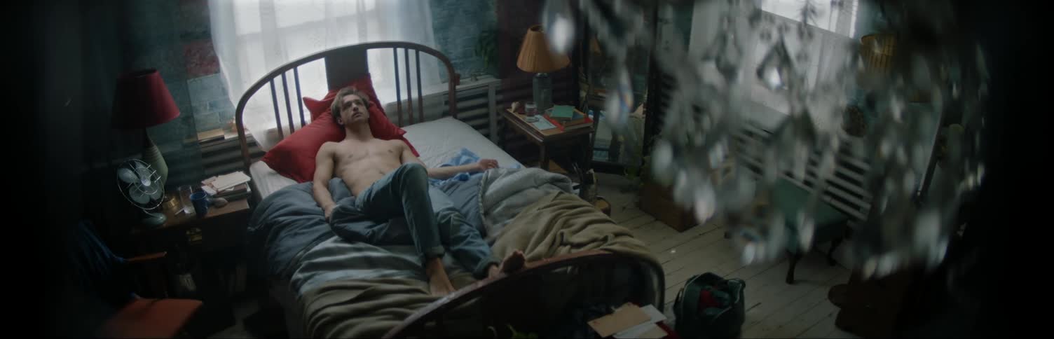 A man lays in a bedroom