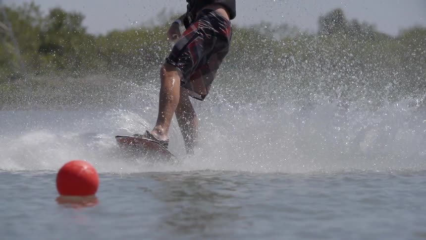 Man water skiing over a lake on a cloudy day