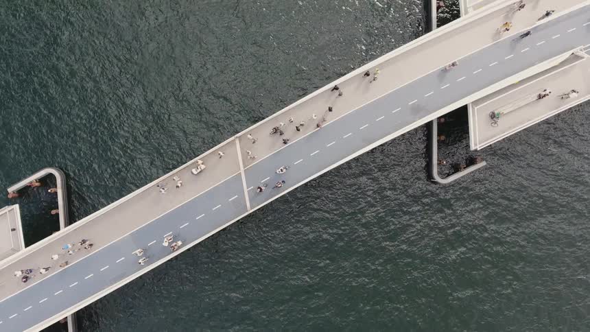 A boat travels under a bridge