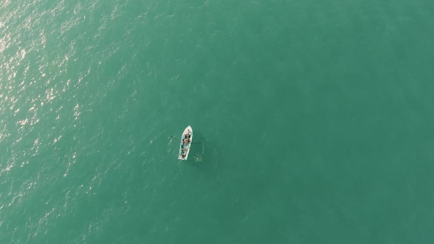 A boat is slowly drifting in a calm sea