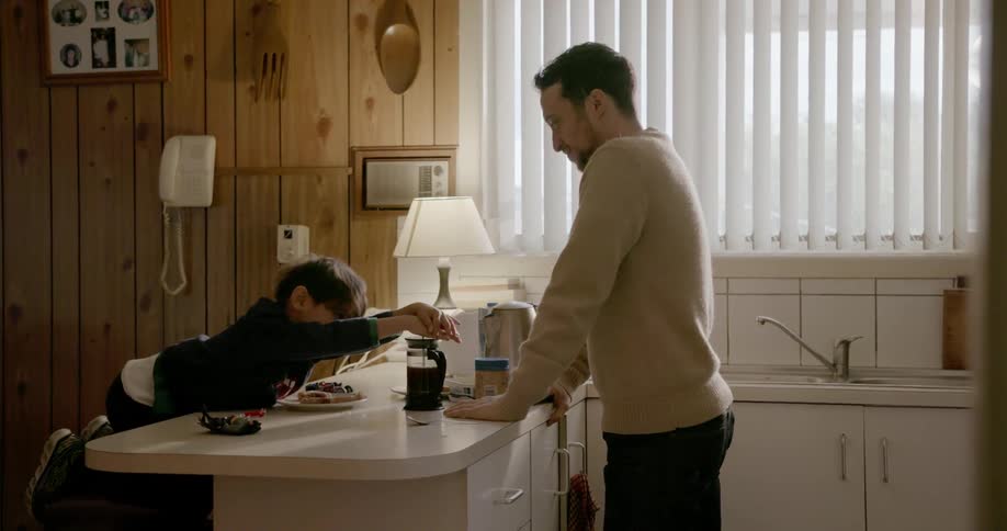 Child pressing coffee in the kitchen 