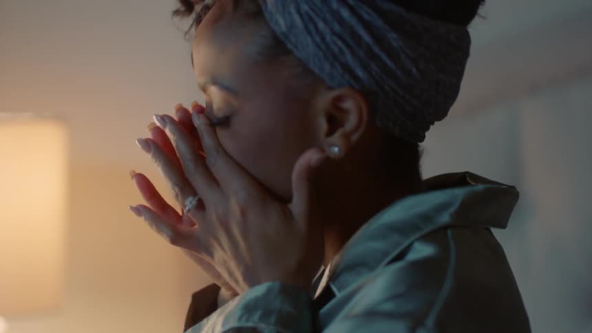 A woman wakes up and turns a lamp on