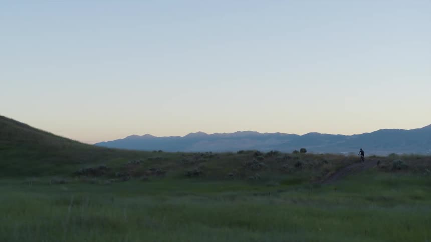 Overlooking a large town from a grass hill