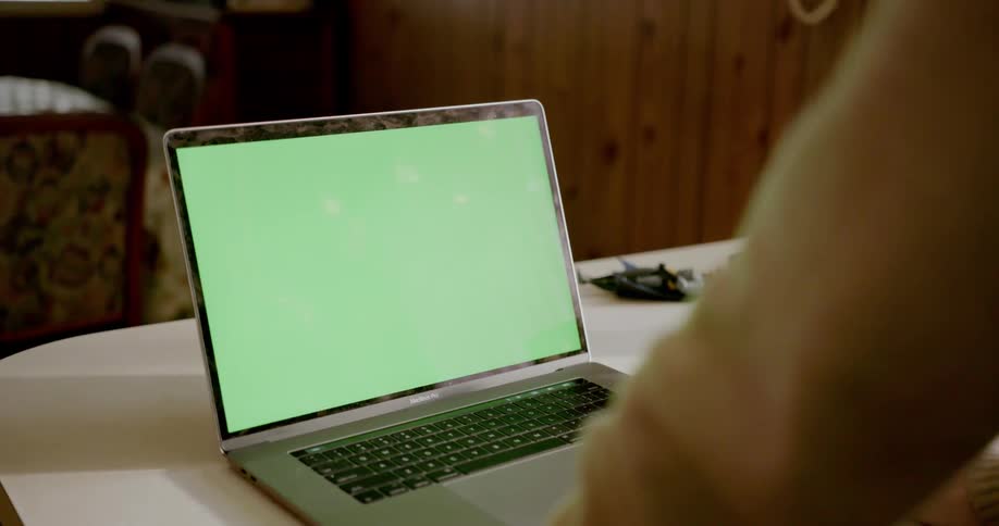 Person using laptop on kitchen counter
