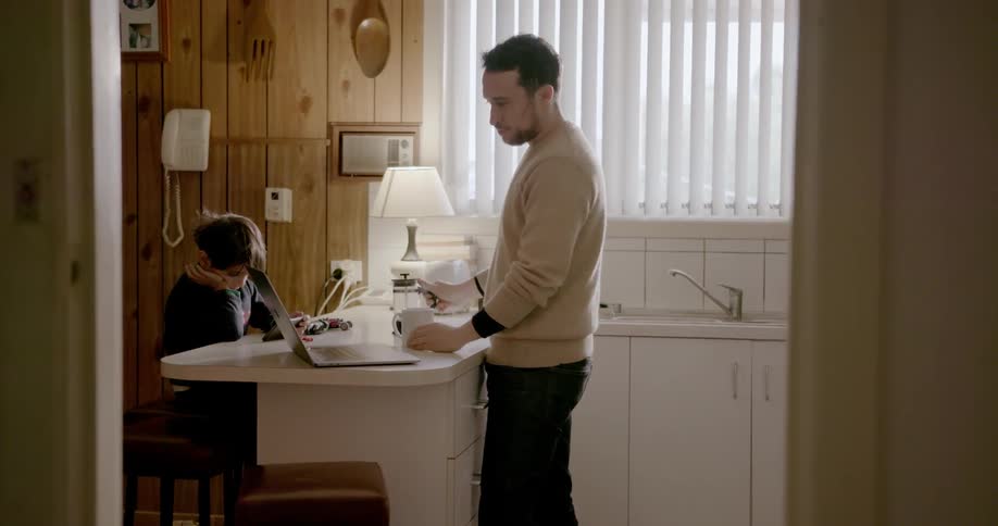 A man pours coffee at the kitchen table