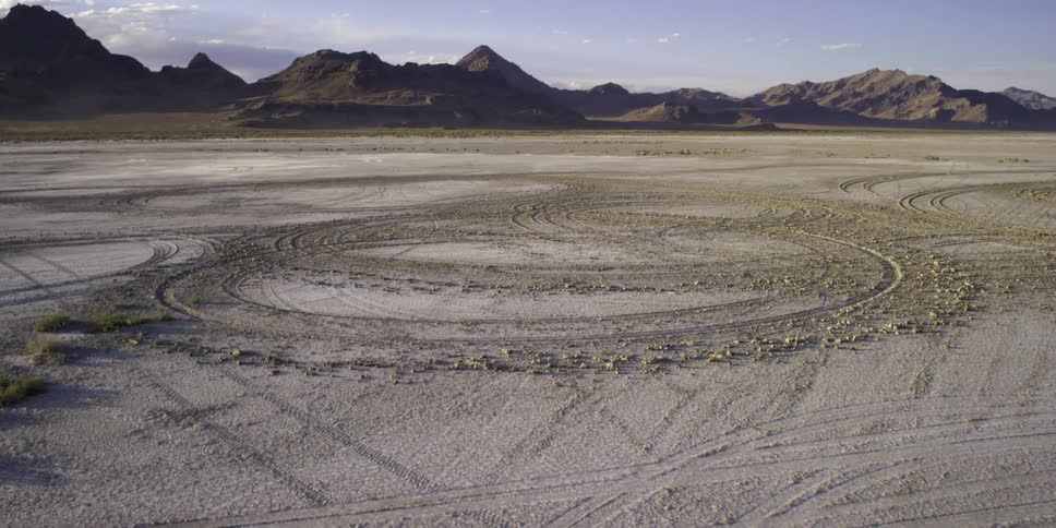 Tire tracks form a circle in the desert