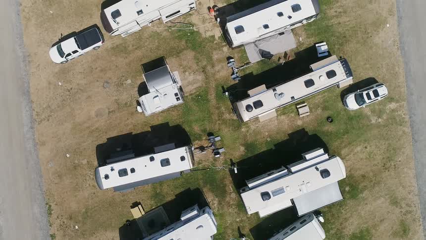 Campers sit parked in a campground lot