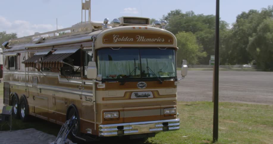 An rv sits parked in a campground lot