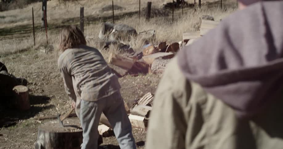 A man chops wood with an ax