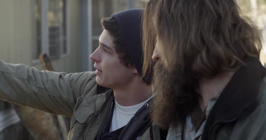 Two men talking and laughing as one points