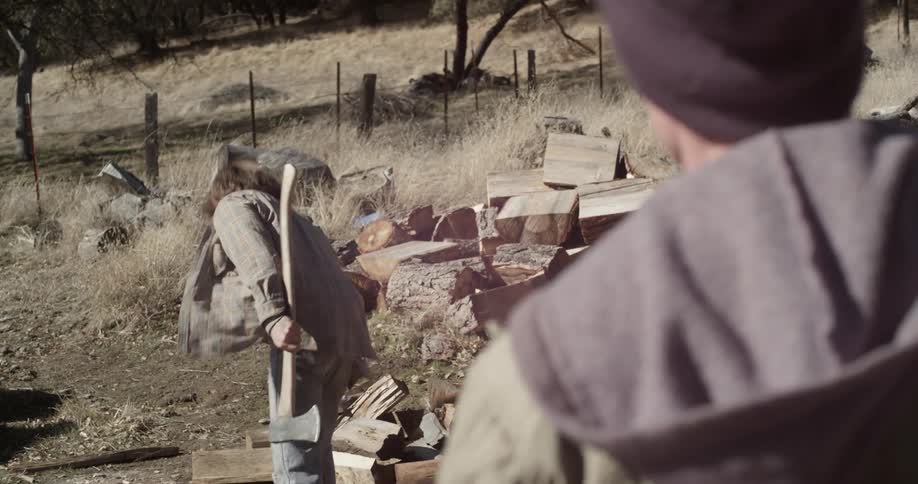 A man chops wood with an axe