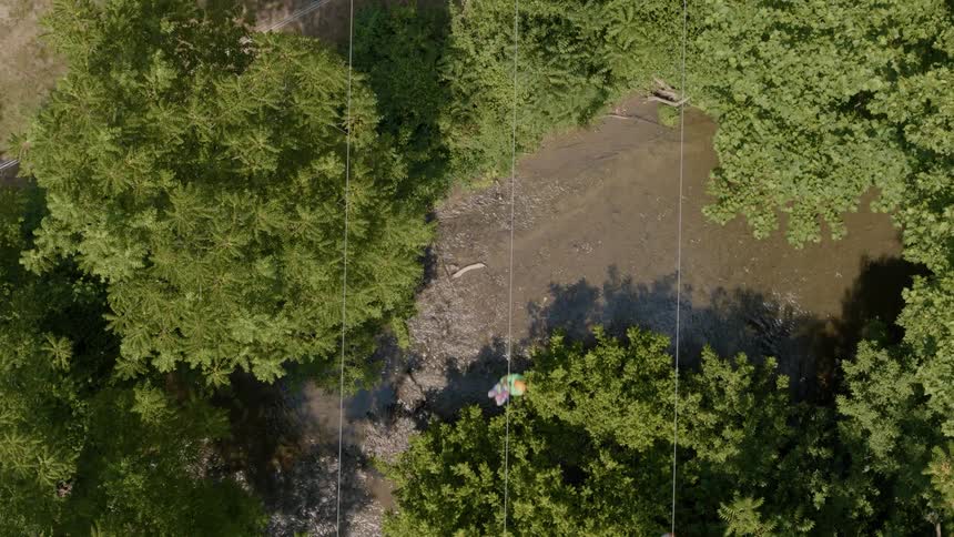 Zip liners are seen flying past the camera