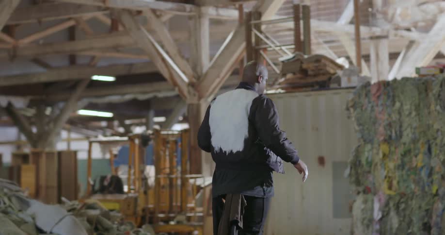 A man walks through a construction site and dances