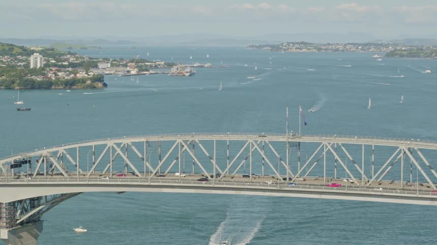 Many cars travel over the long bridge
