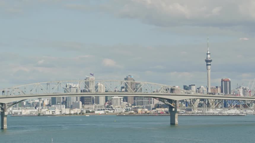 A bridge over water near a city